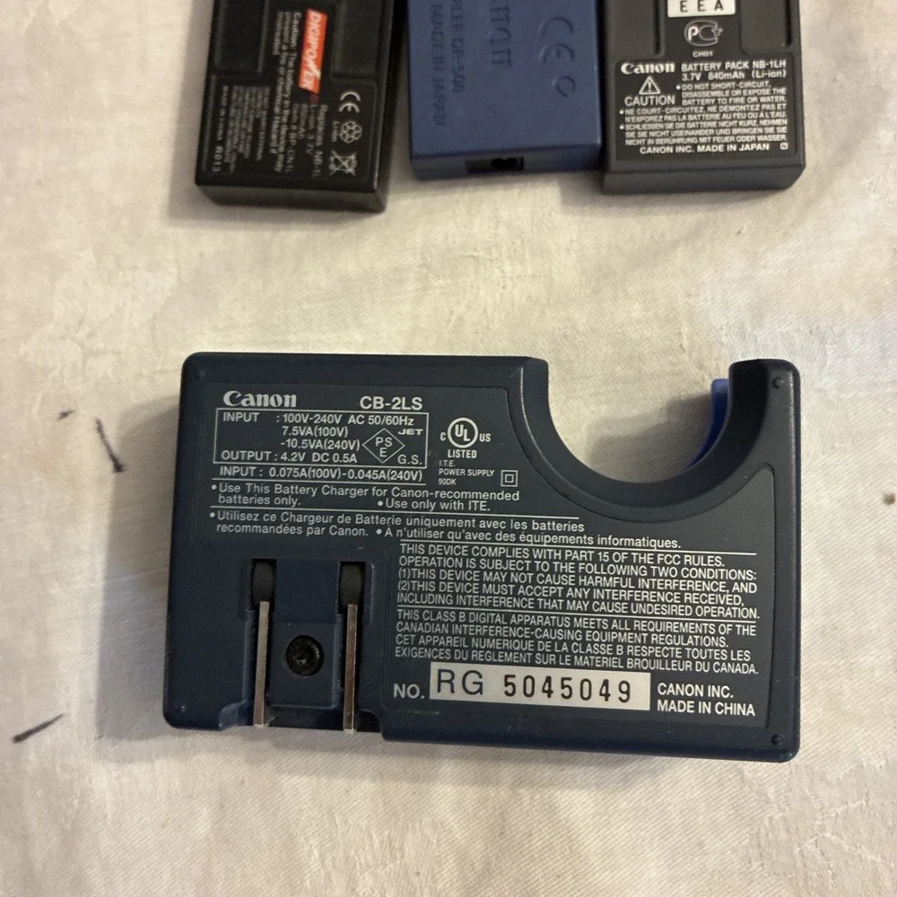 canon battery charger CB-2LS, 3 batteries, And One Sim Card Working